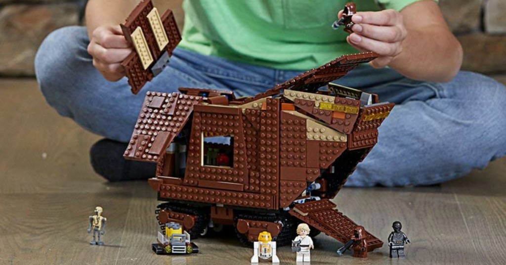 boy playing with LEGO Sandcrawler set