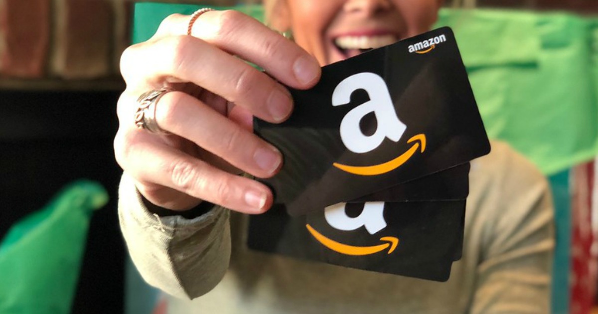 two amazon gift cards in woman's hand