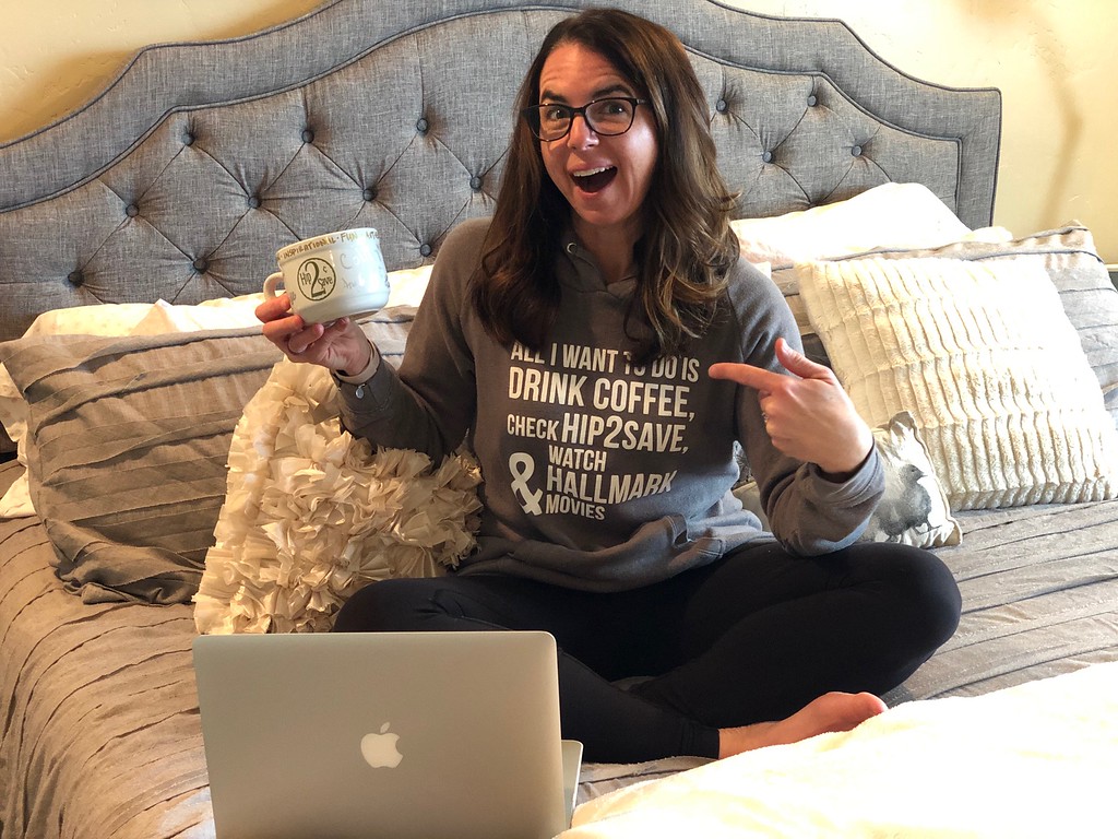 Brynn drinking coffee and sitting on her bed