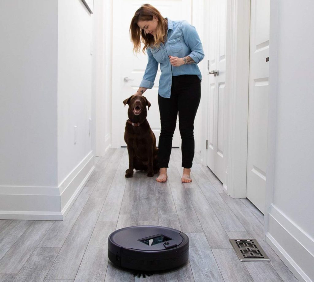 Woman next to dog with bobsweep vacuum nearby