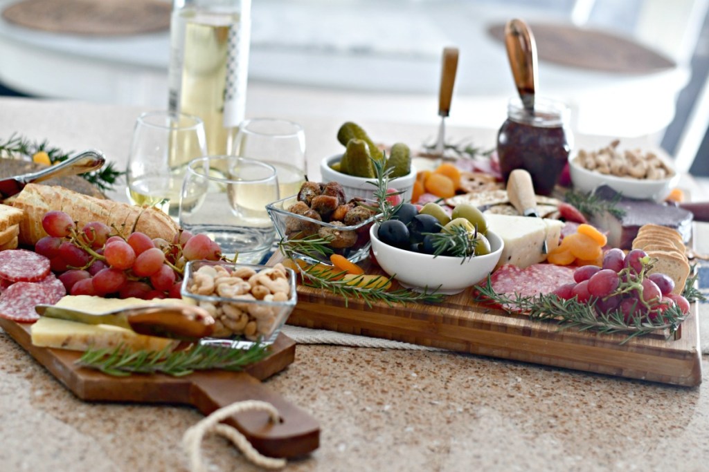 charcuterie board with meats, cheese, olives, grapes 