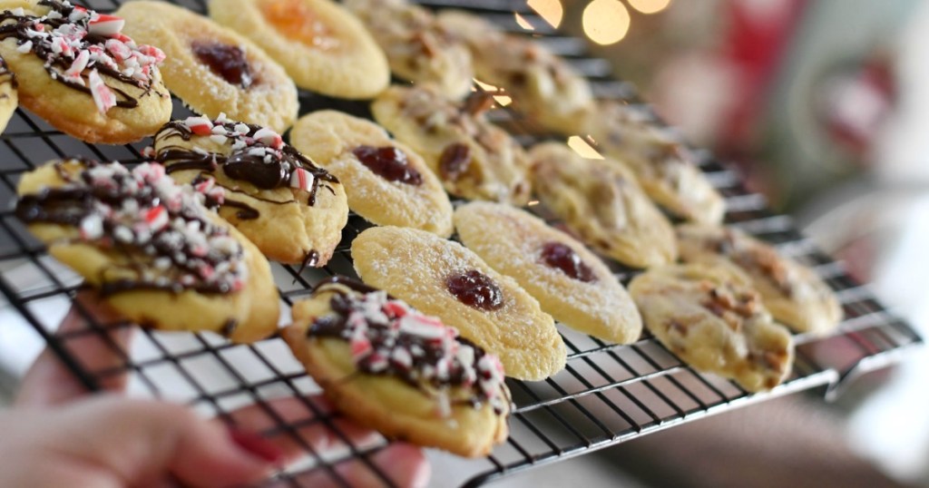 holding Christmas cookies on cooling rack