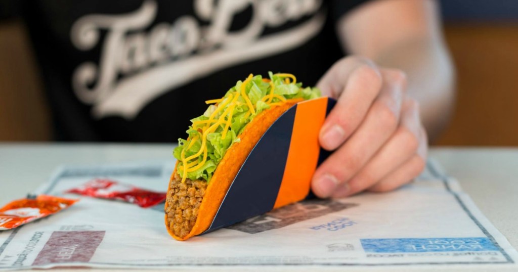 man holding doritos locos taco wearing a black shirt