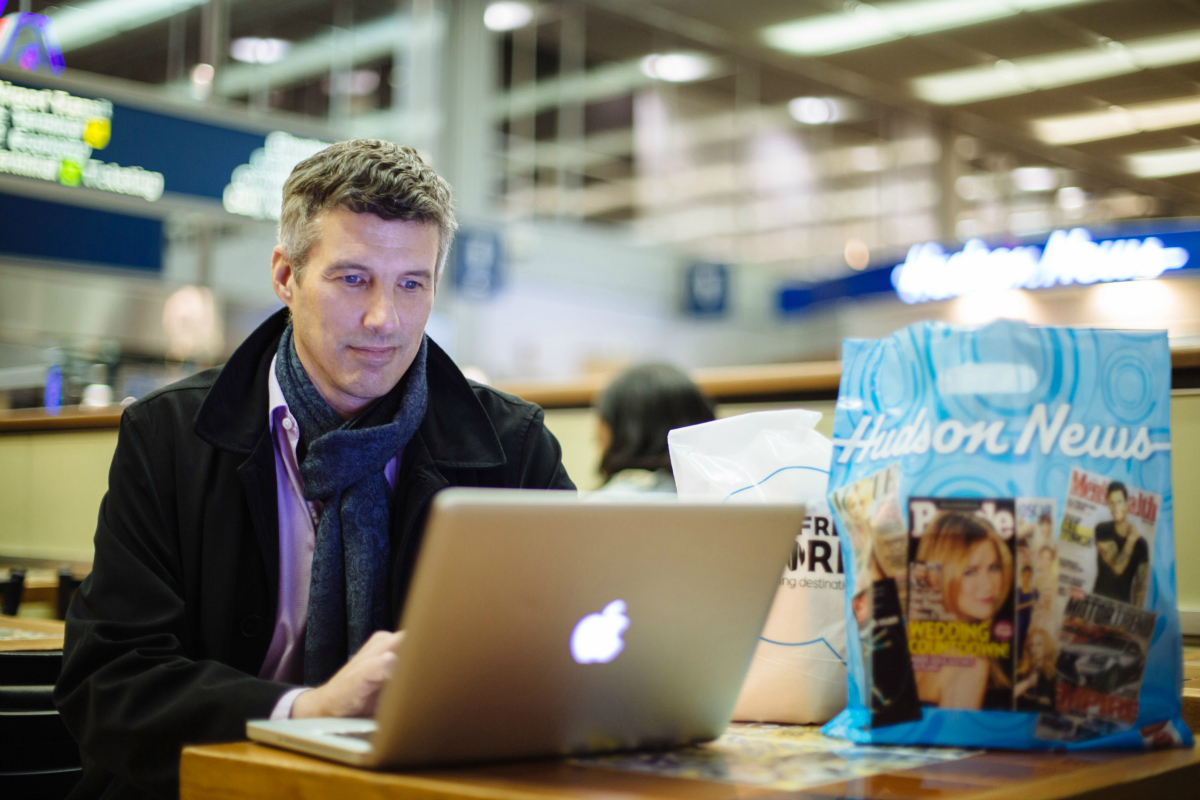 Hudson News man using a laptop