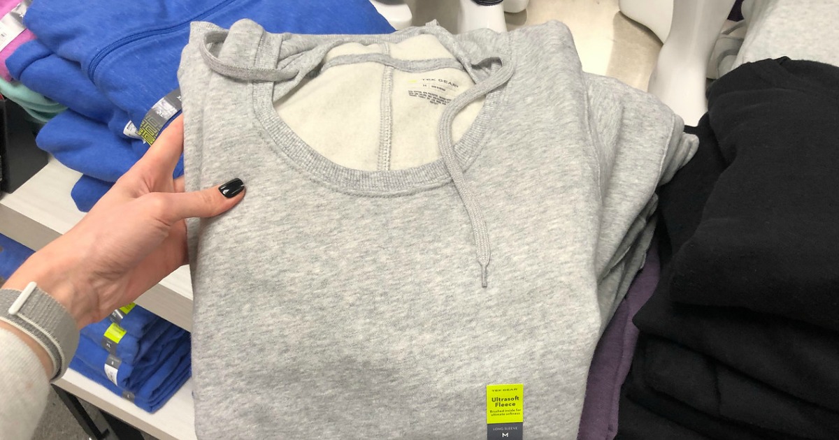 hand holding up grey sweatshirt