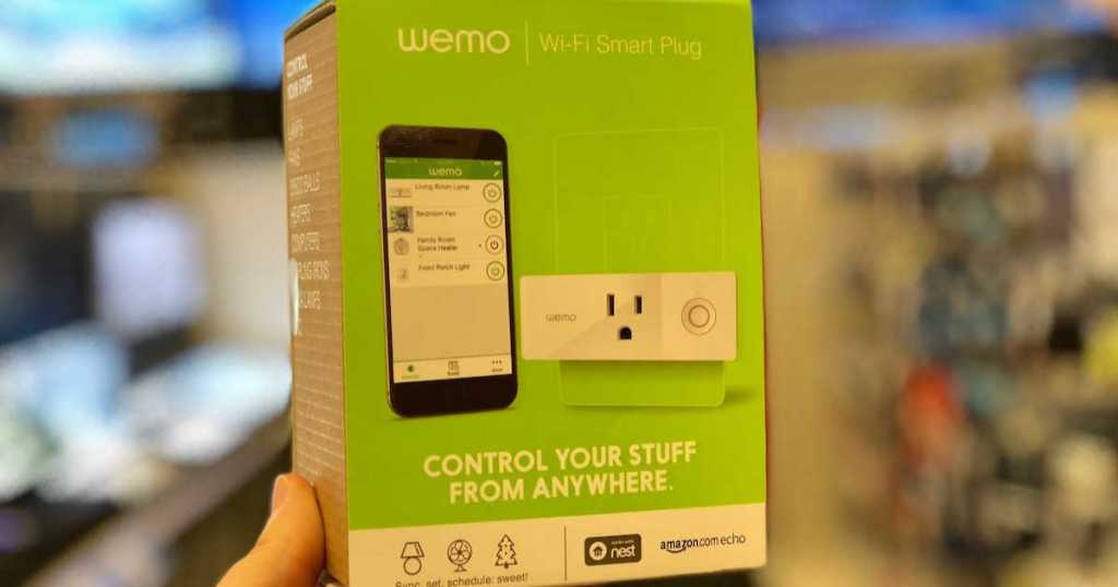 Hand holding Wemo wifi Smart Plug