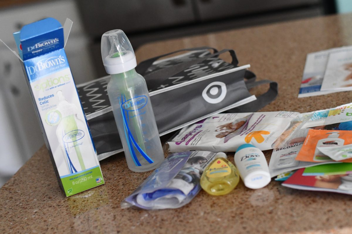 Target baby registry bag with bottle, sample size products, gift bag, and coupons.