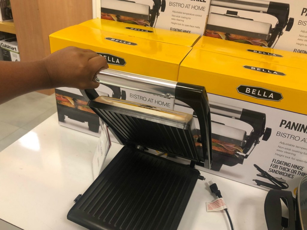 hand lifting up bella panini grill in store