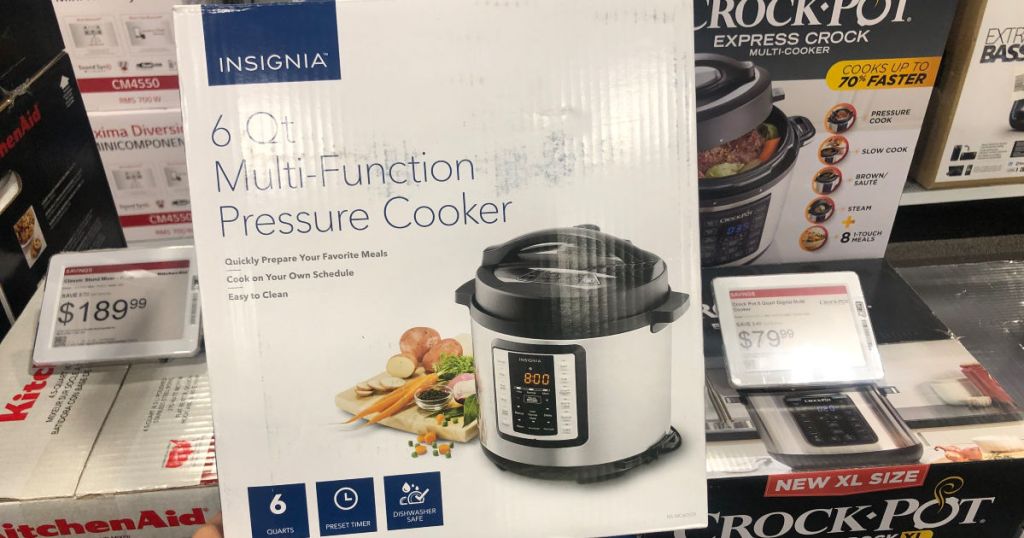 Pressure cooker sitting in the store by other small kitchen appliances