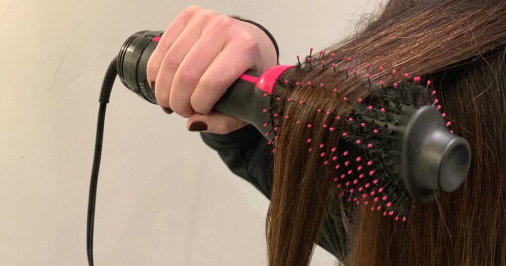 person drying hair with Revlon hairbrush