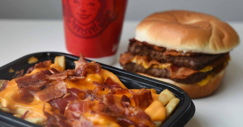 baconator fries with burger and drink in the background