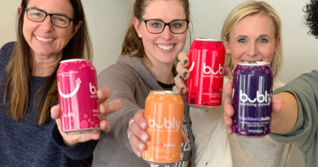 women holding up various cans of bubly sparkling water