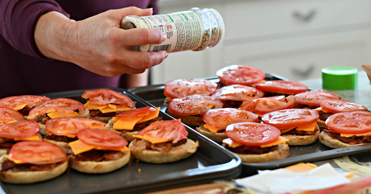 garlic salt seasoned tomato slice on top of english muffins 