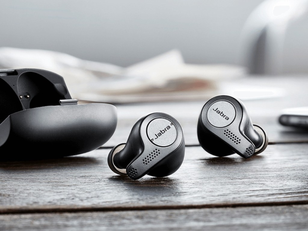 jabra elite earbuds on counter next to case