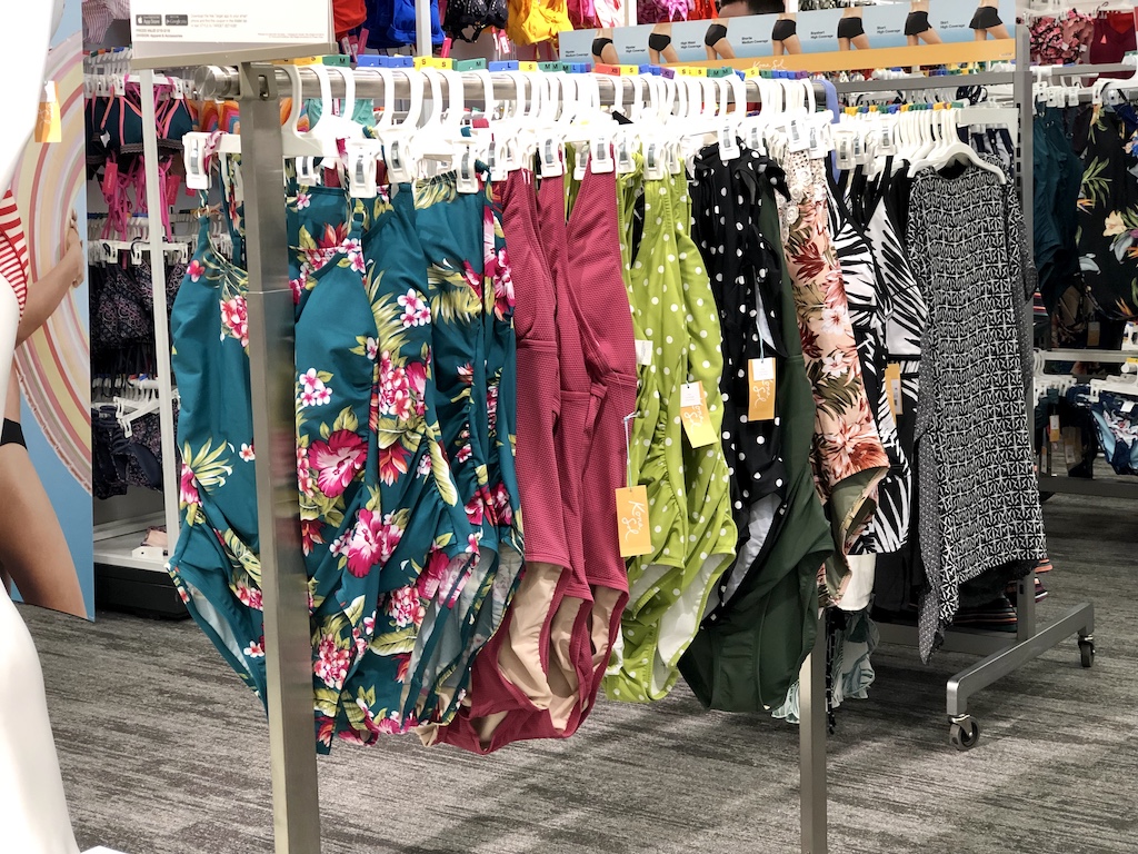 women's one-piece swimsuits on a clothing rack