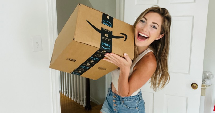 woman holding amazon box and smiling