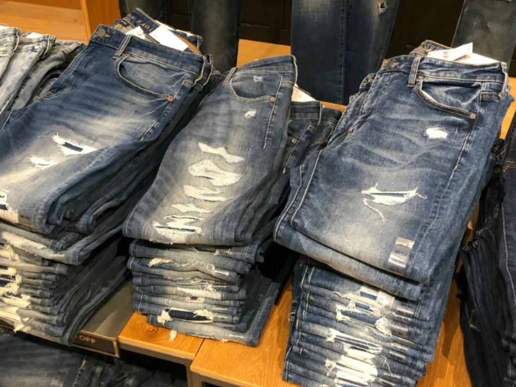 jeans in a stack on a shelf in a store