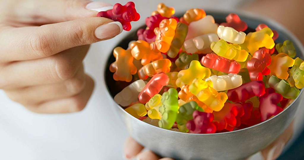 hand holding bowl of Black Forest gummy bears