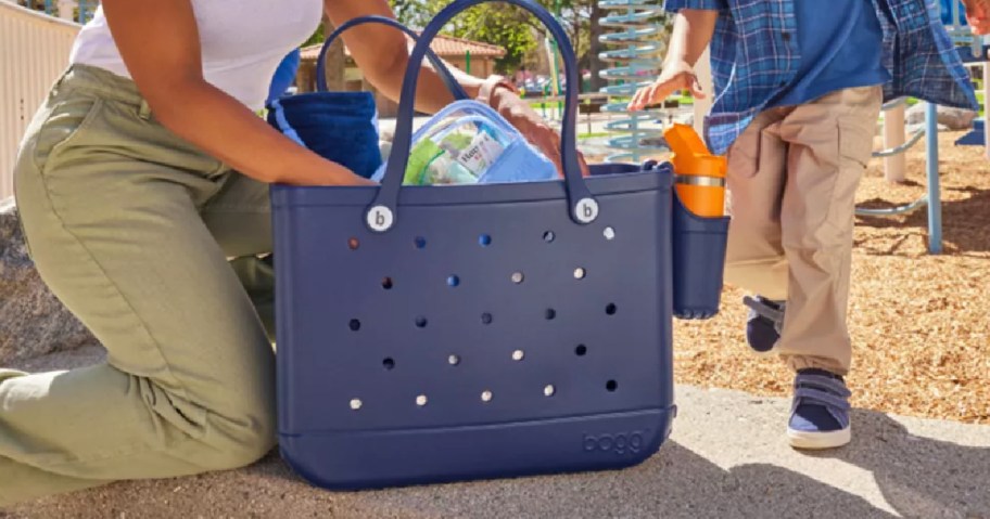 adult with packed navy blue Bogg bag
