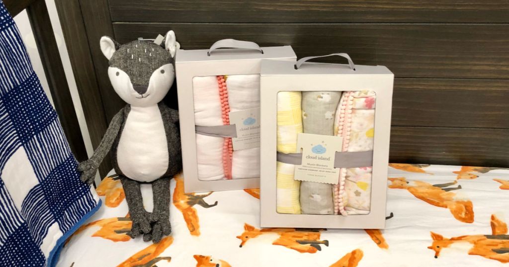 swaddle blankets in a box next to stuffed animal