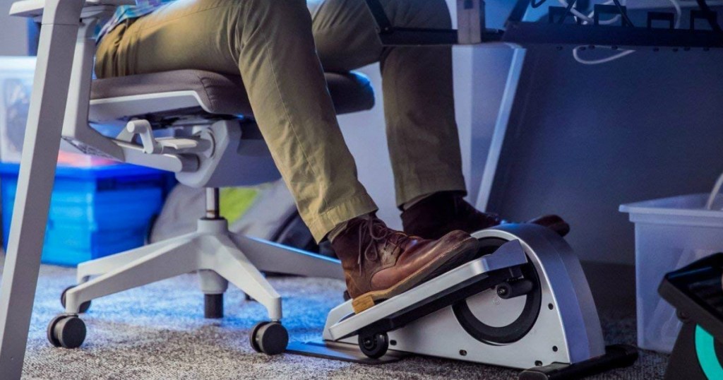 man using elliptical at desk