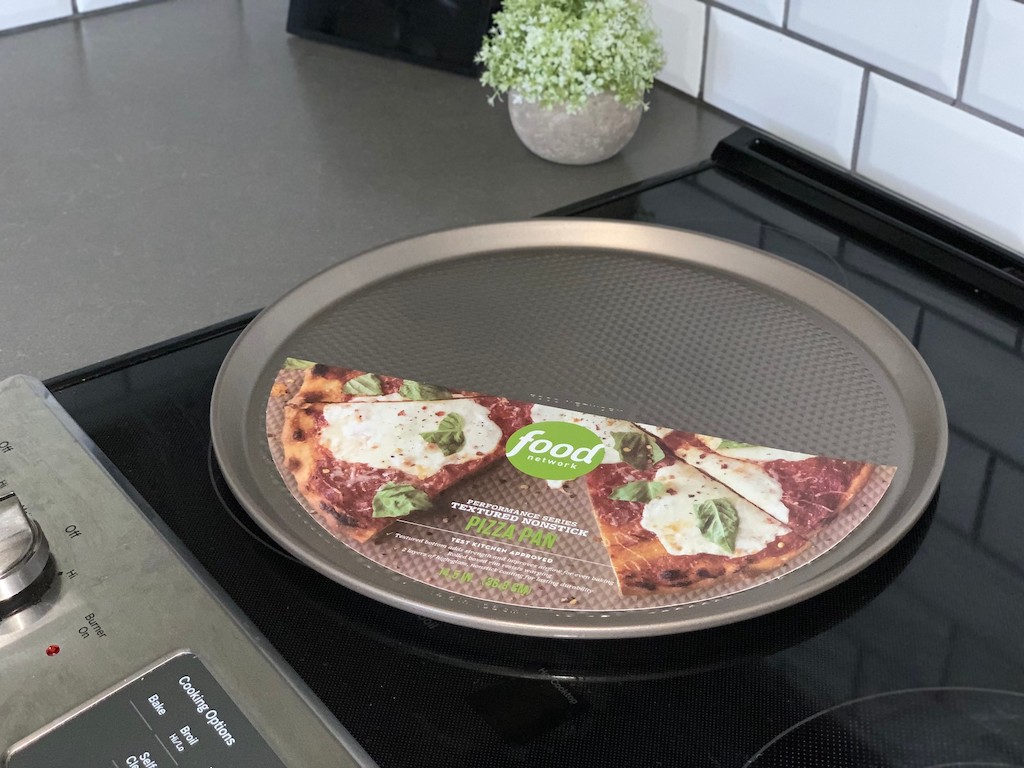 food network pizza pan on a glass stovetop