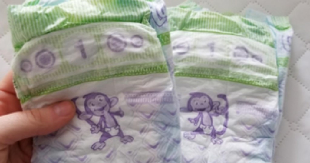 hand holding diapers with monkey picture on them