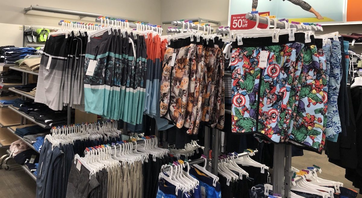 men's swim trunks hanging on clothing racks at Target