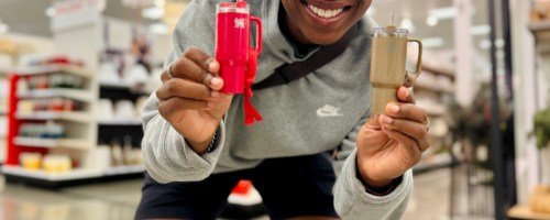 Person holding up two small Stanley Tumbler ornaments