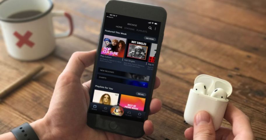 smartphone with amazon music pulled up and airpods