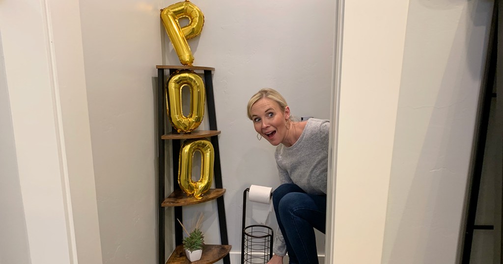 woman sitting on toilet with Poo balloons 