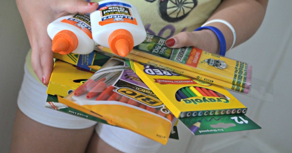 girl holding school supplies