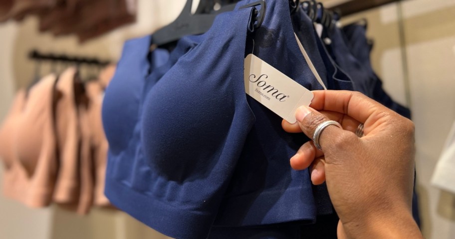 woman holding a tag on a blue soma bra