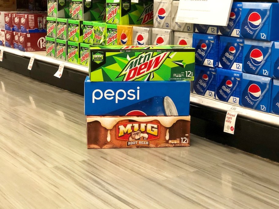 boxes of soda cans stacked in a store