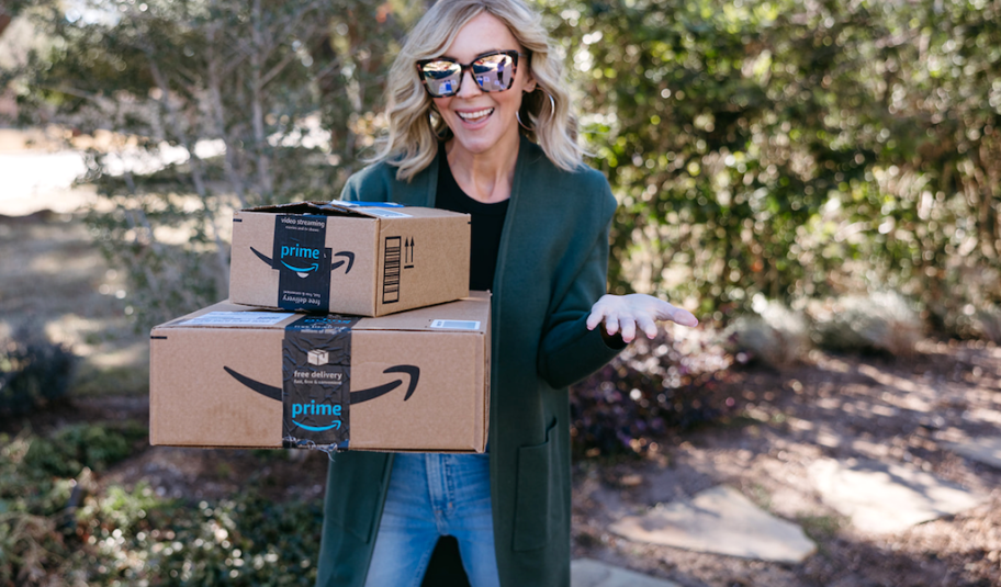 woman holding Amazon boxes outside