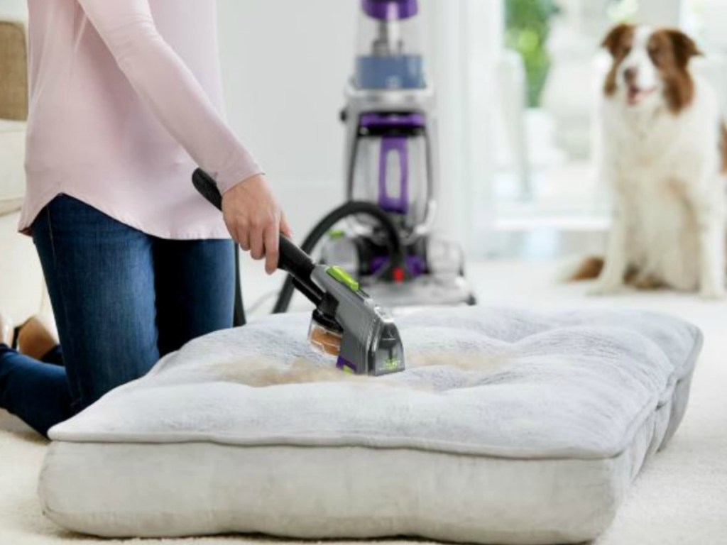 woman using tool from BISSELL ProHeat 2X Revolution Pet Pro Carpet Cleaner on couch