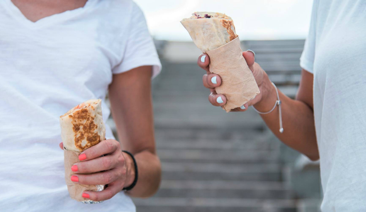 El Pollo Loco people holding burritos for National Burrito Day