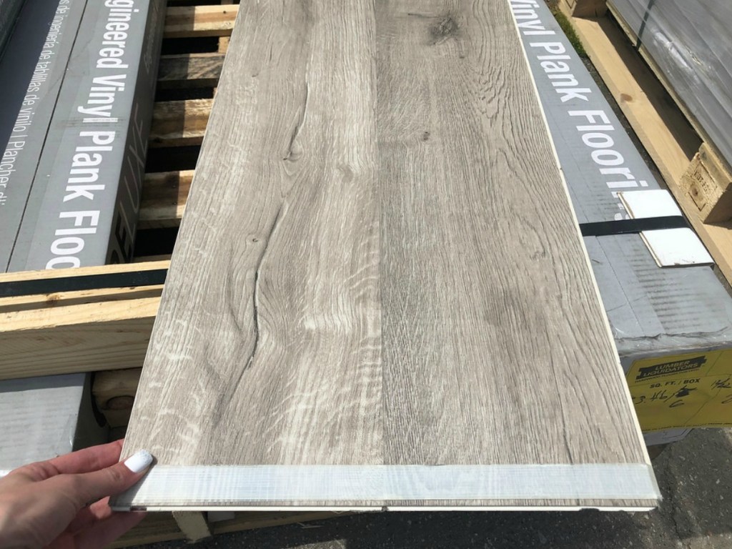 Lumber Liquidators Vinyl Plank Flooring Plank Held in Woman's Hand