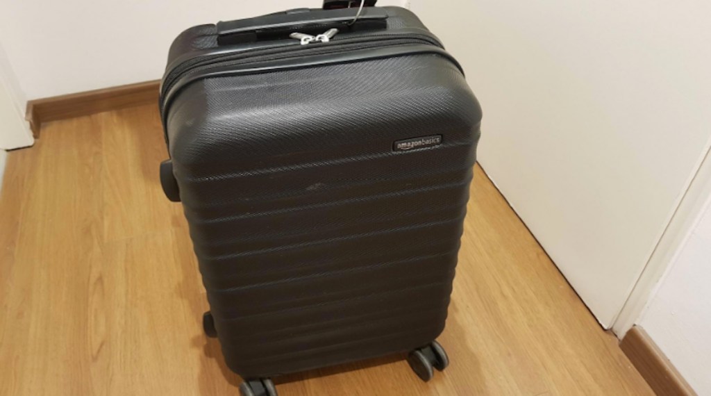 black luggage sitting on wood floor 