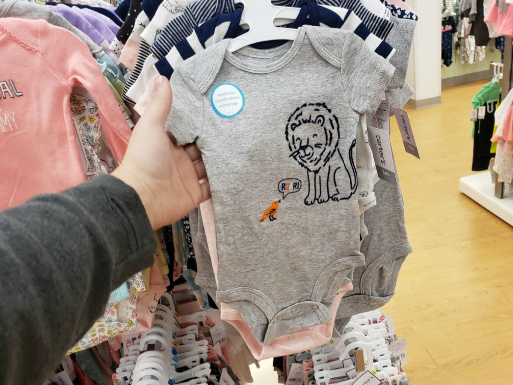 Person holding Carter's 5-piece boys bodysuit set 