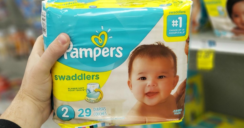 hand holding package of diapers