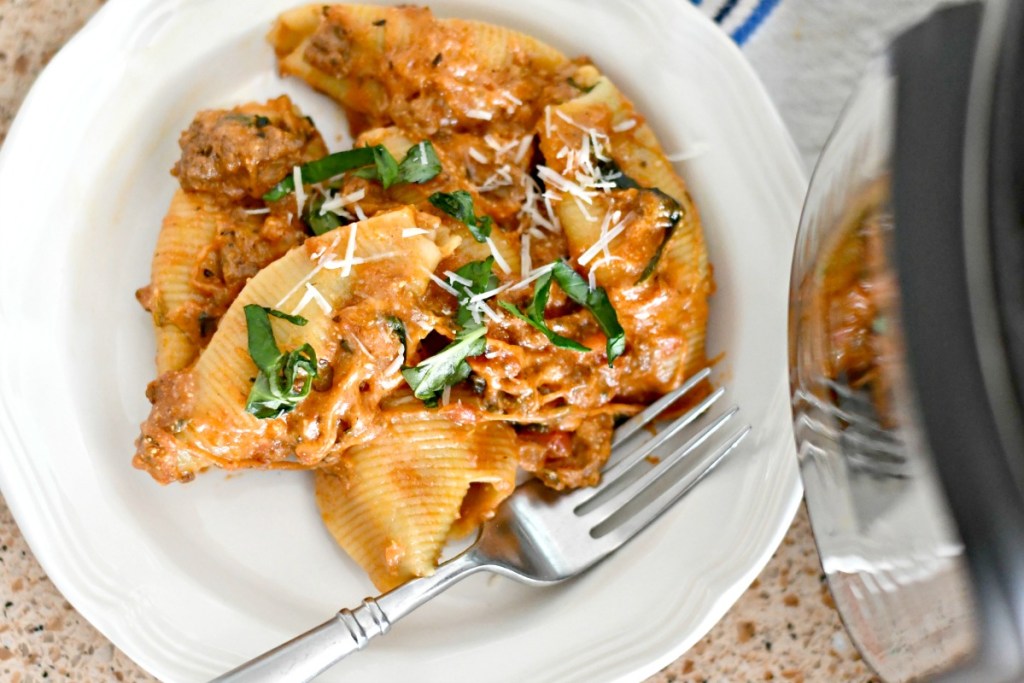 plated instant pot stuffed shells topped with basil