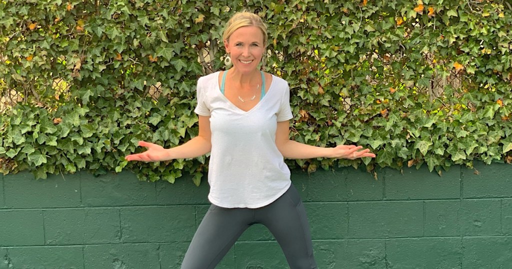 woman standing outside with hands out to her side