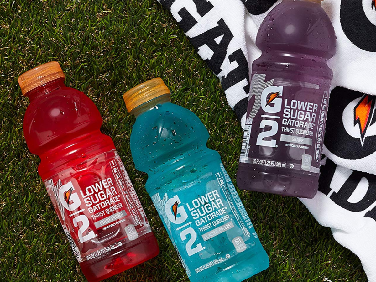 Three Gatorade G2 Thirst Quencher bottles on grass with towel