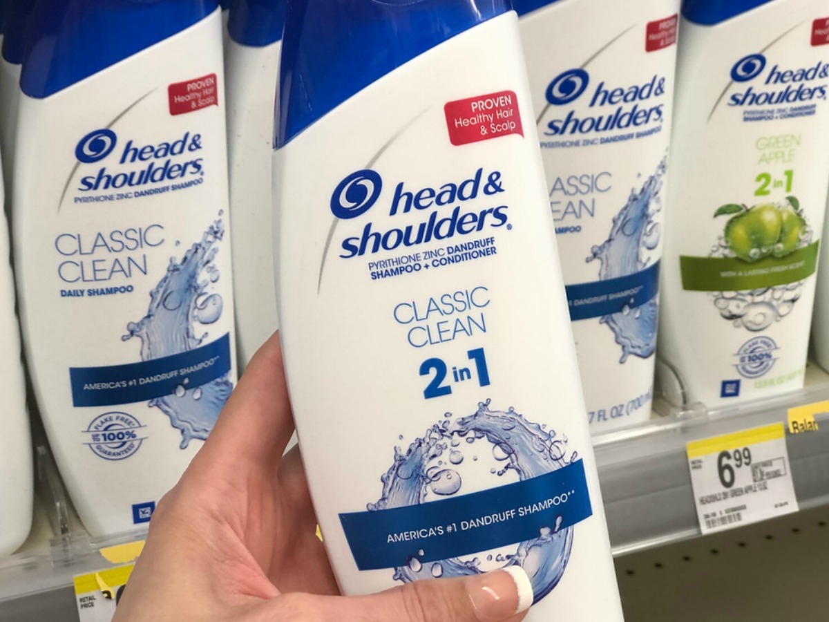 Woman holding Head & Shoulders Shampoo at Walgreens