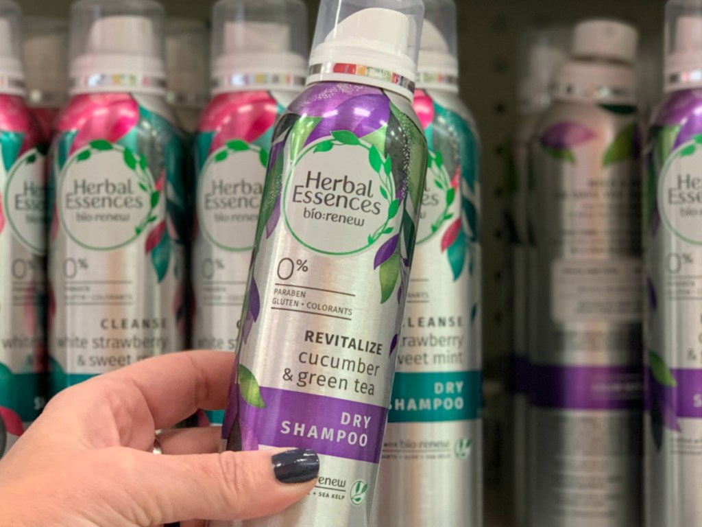 Woman holding Herbal Essences Dry Shampoo