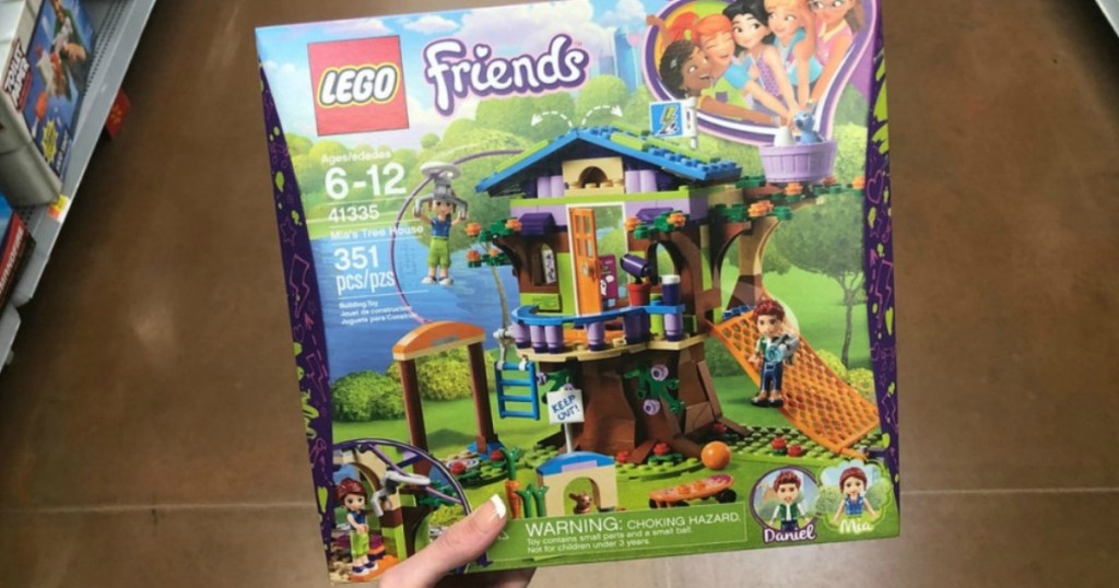 hand holding LEGO Friends Mia's Treehouse box