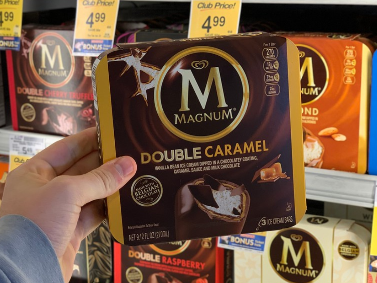 Man holding Magnum Ice Cream Double Caramel Bars Box