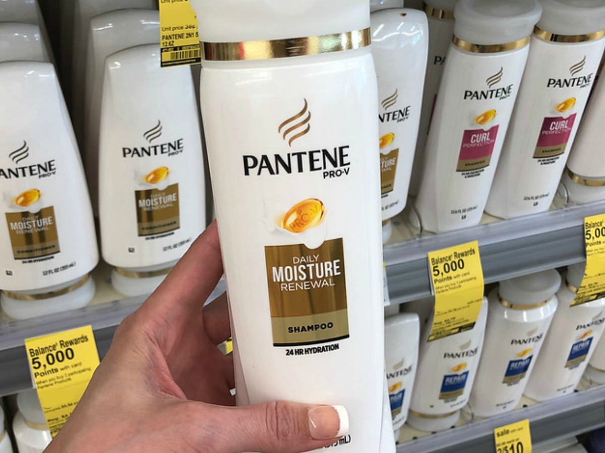 Woman holding Pantene Shampoo at Walgreens