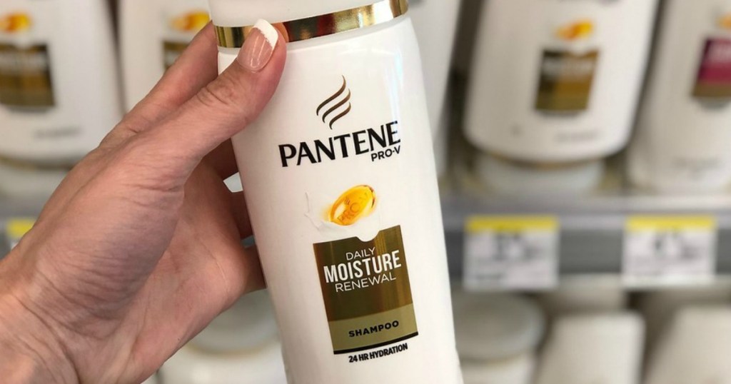 Woman's Hand holding Pantene Shampoo with blurred Walgreens Background